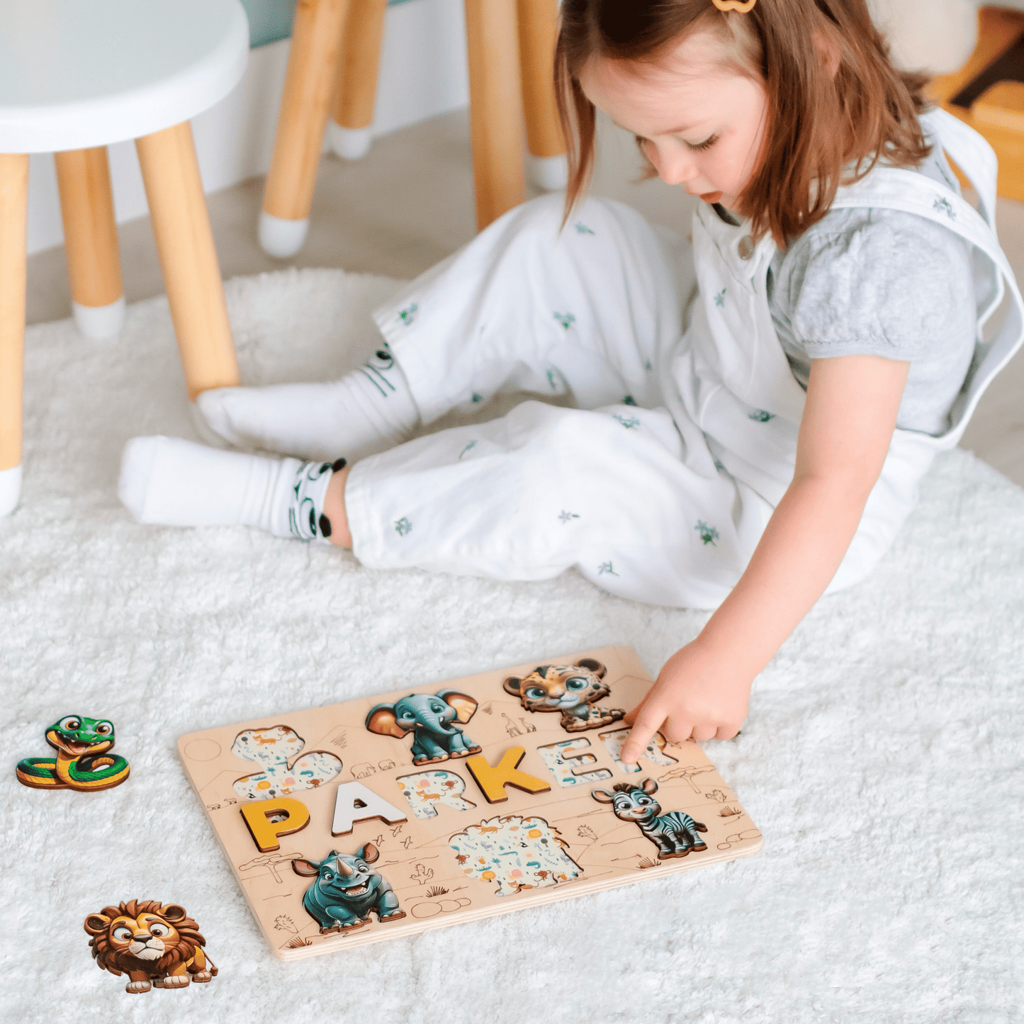 Montessori name puzzle with lion, elephant, and zebra