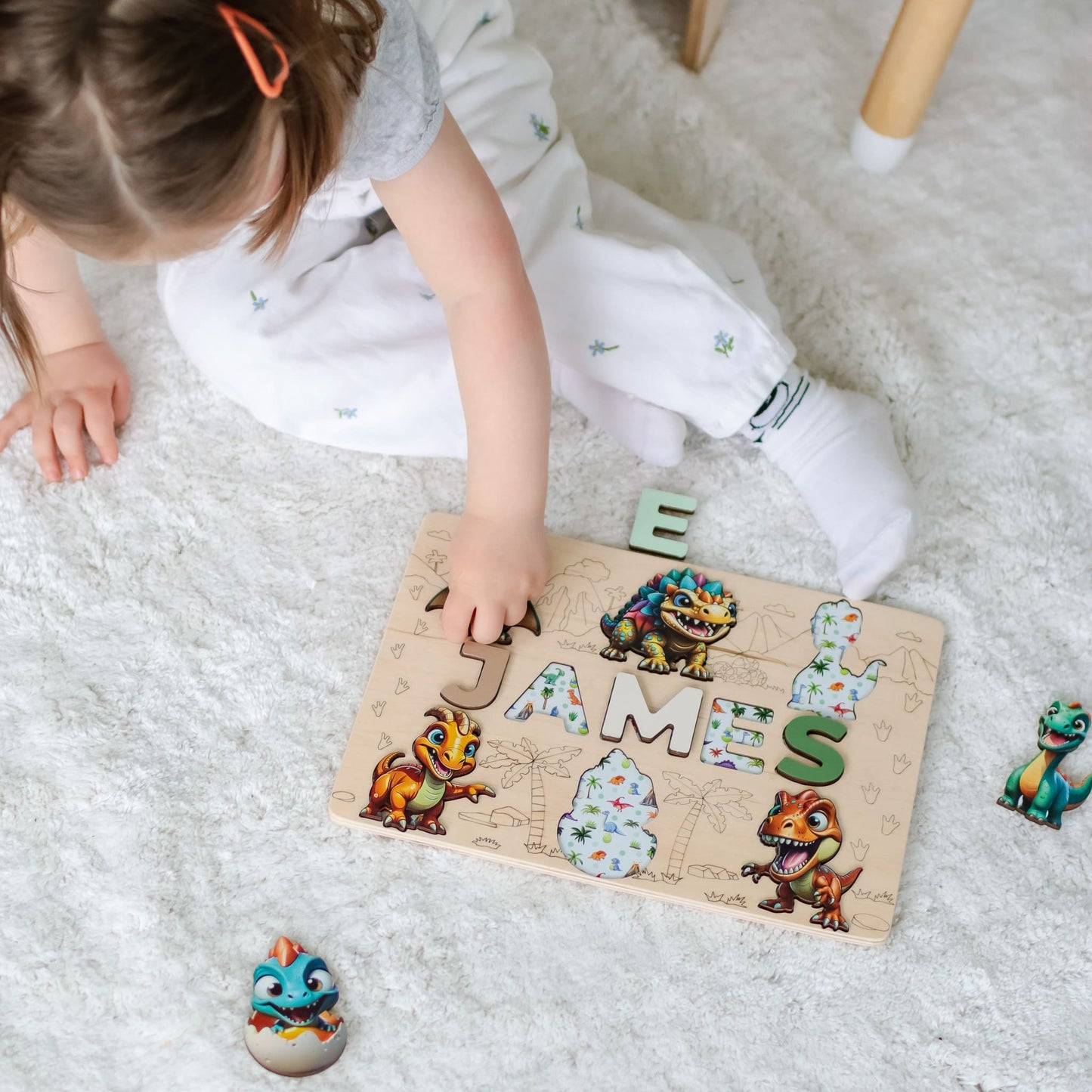 Name puzzle for kids with Jurassic-style artwork