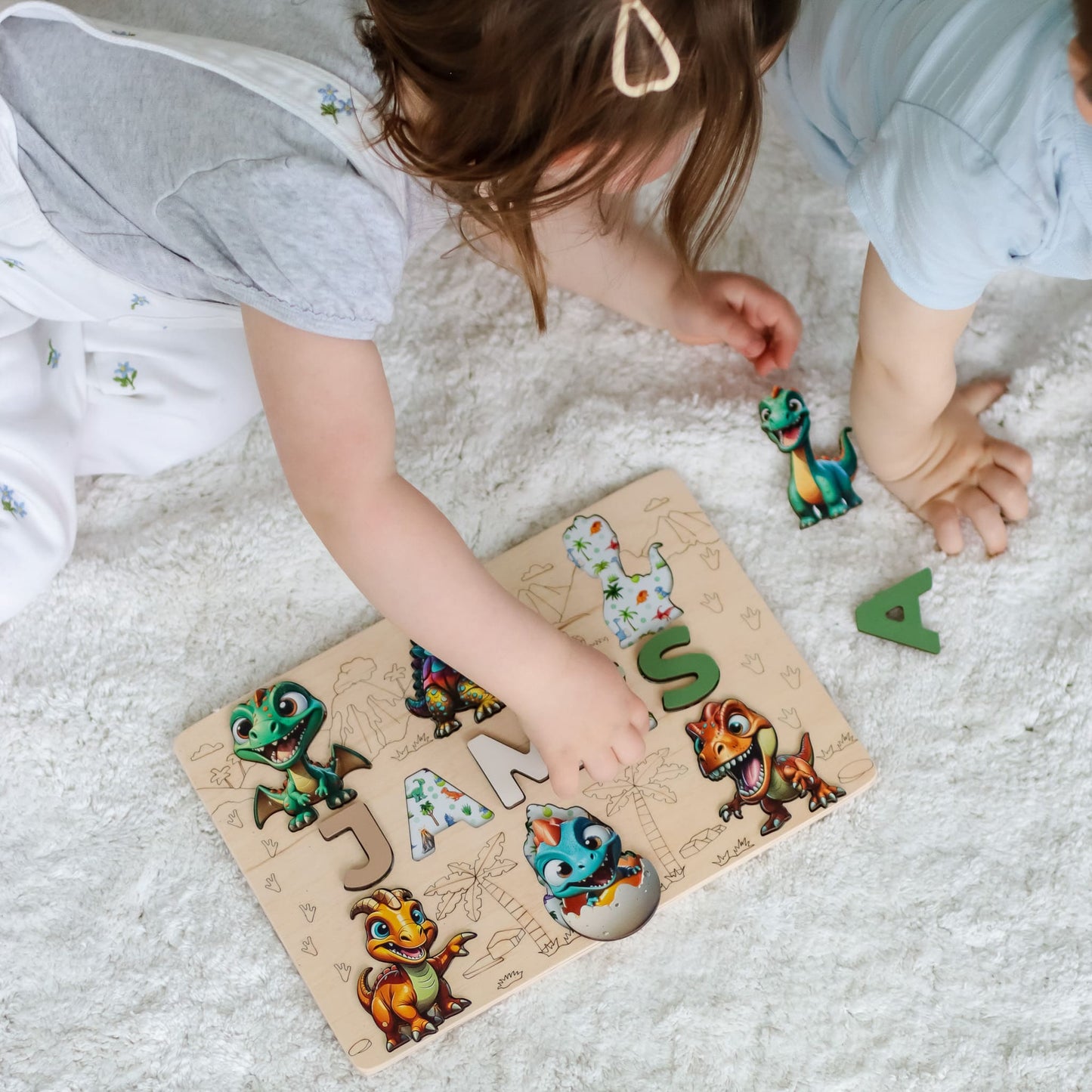 Wooden puzzle with child’s name and magnetic dinos