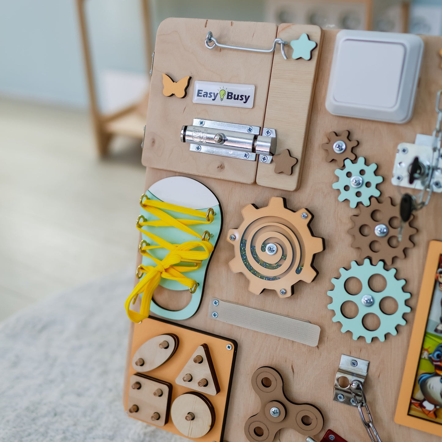Toddler playing with a wooden busy board designed for learning