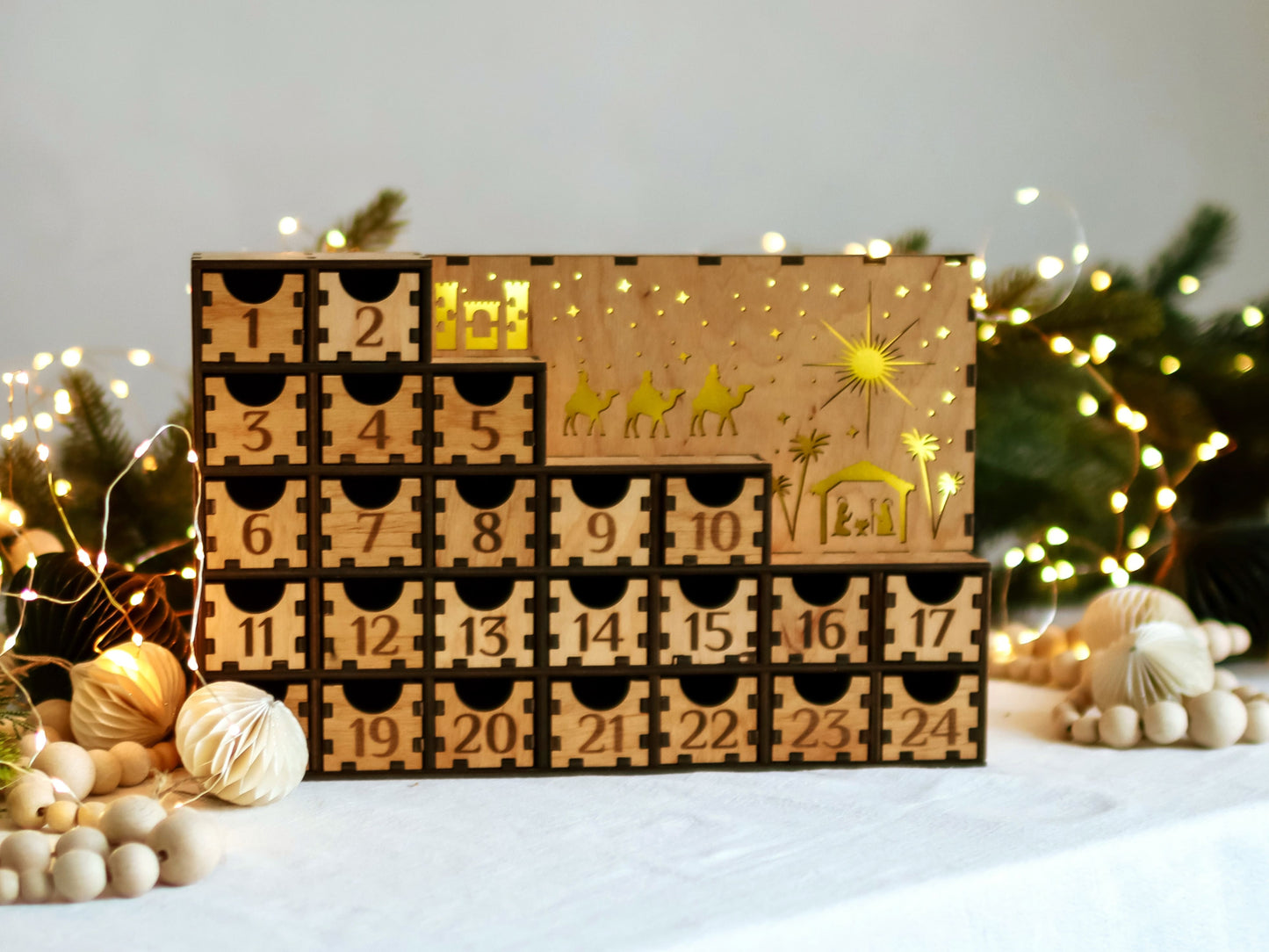Handmade wooden Advent calendar featuring 24 large pull-out drawers and warm LED lights, perfect for Christmas countdown and festive decorations