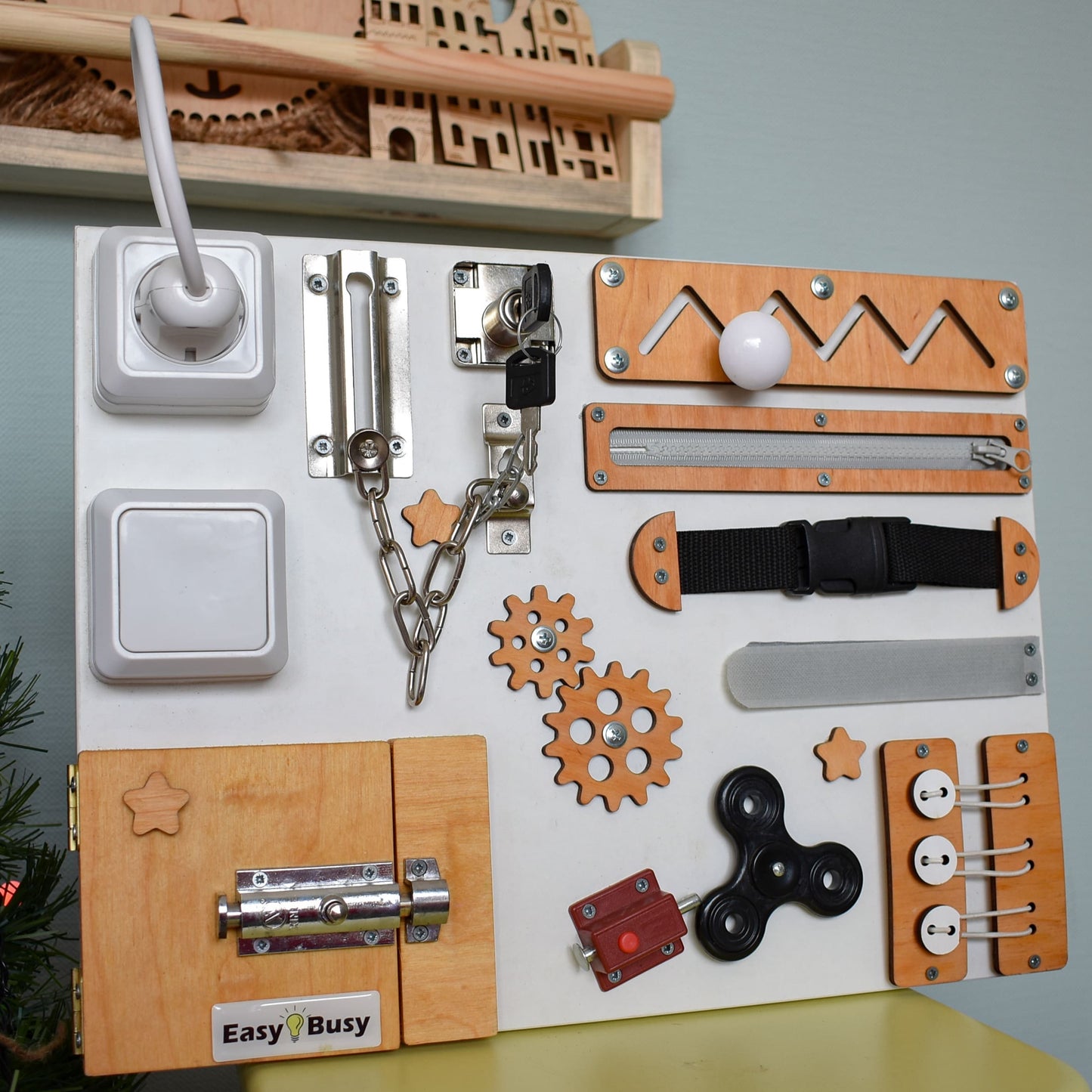 Montessori busy board in white and wood with black fidget spinner