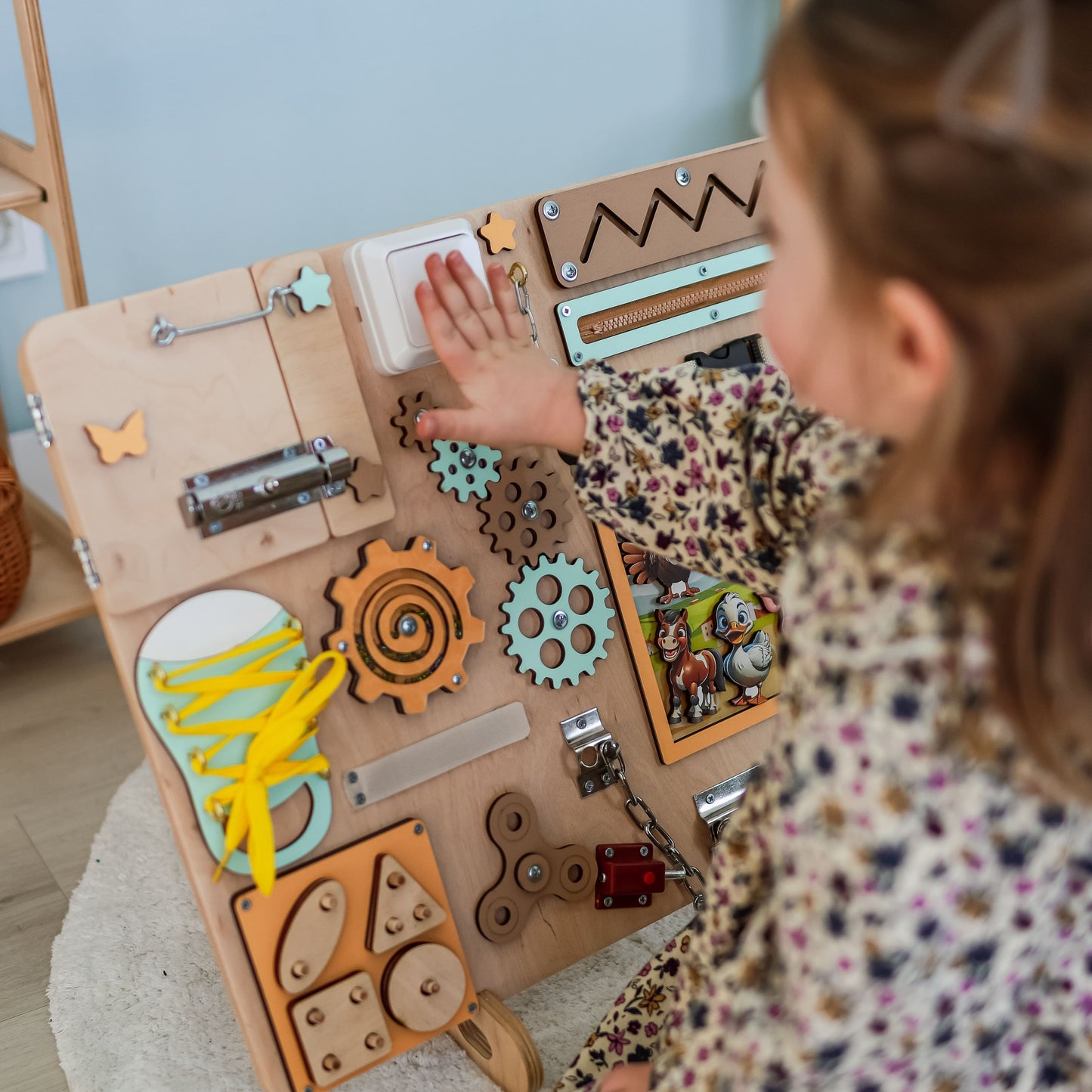 Handmade wooden sensory play board with a barnyard theme