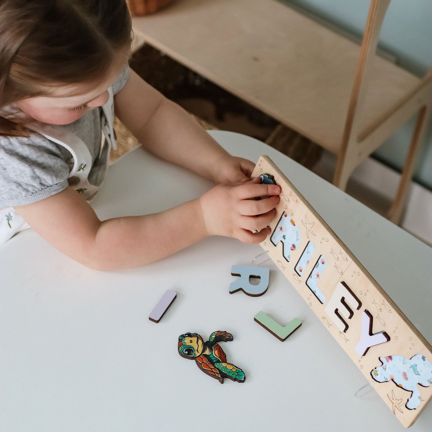 Wooden puzzle with whale and coral engraving
