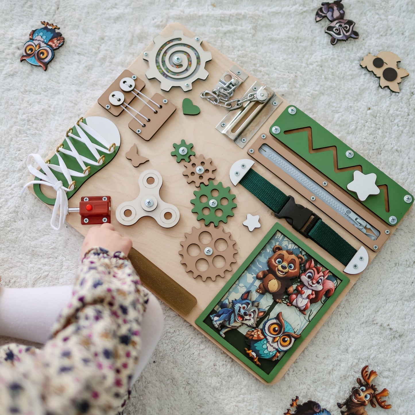 Magnetic fox and deer on an interactive sensory play board