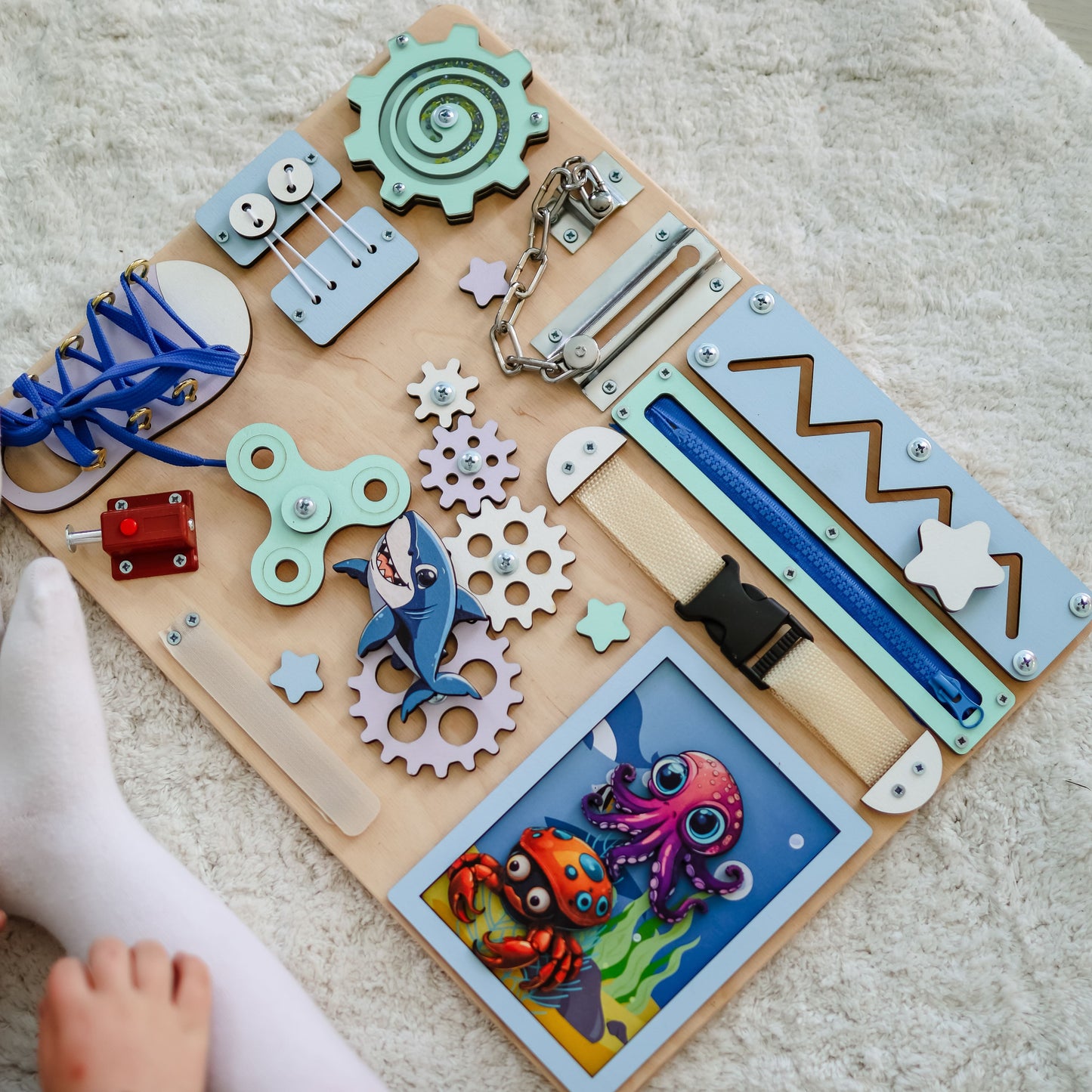 Toddler arranging magnetic sea animals on an interactive activity board