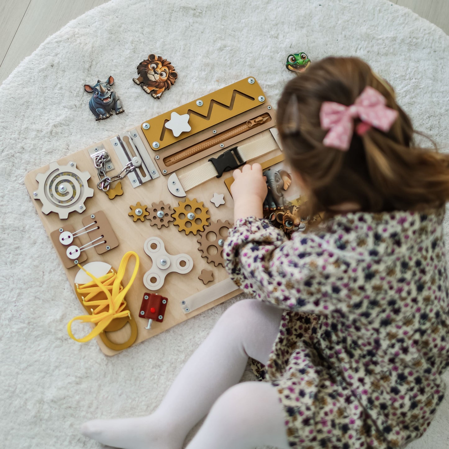 Handmade safari-themed busy board with removable magnetic animals