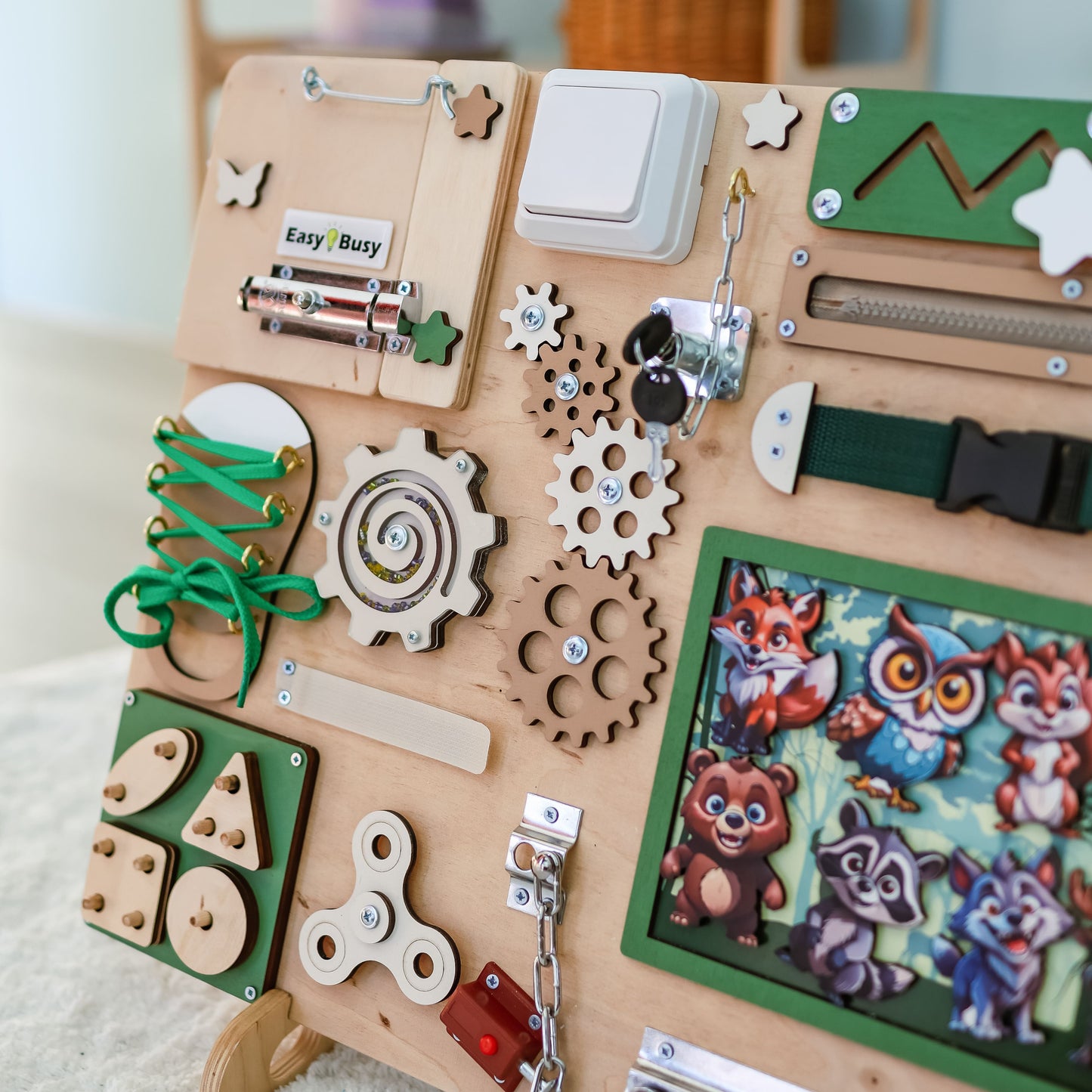 Handmade wooden busy board featuring a detailed forest scene