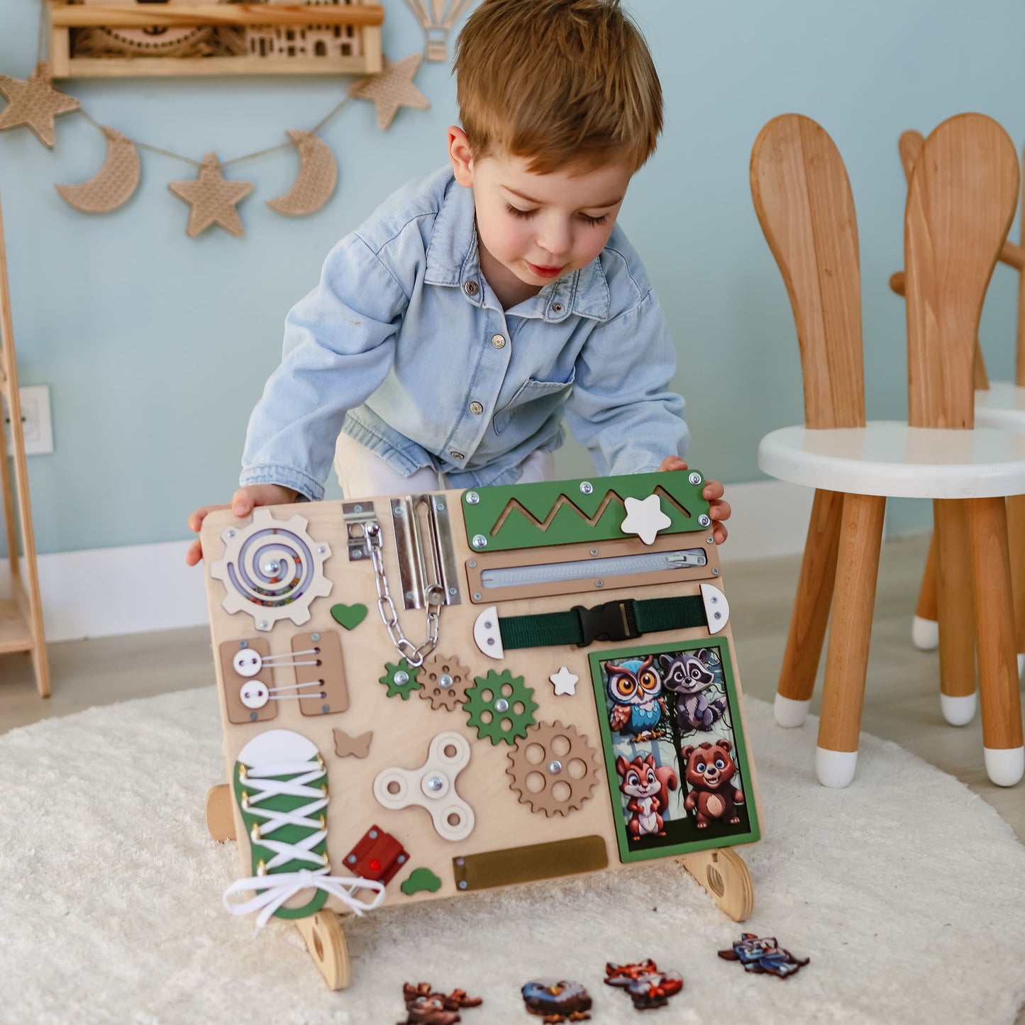 Fox, owl, and bear magnets on an educational busy board for kids