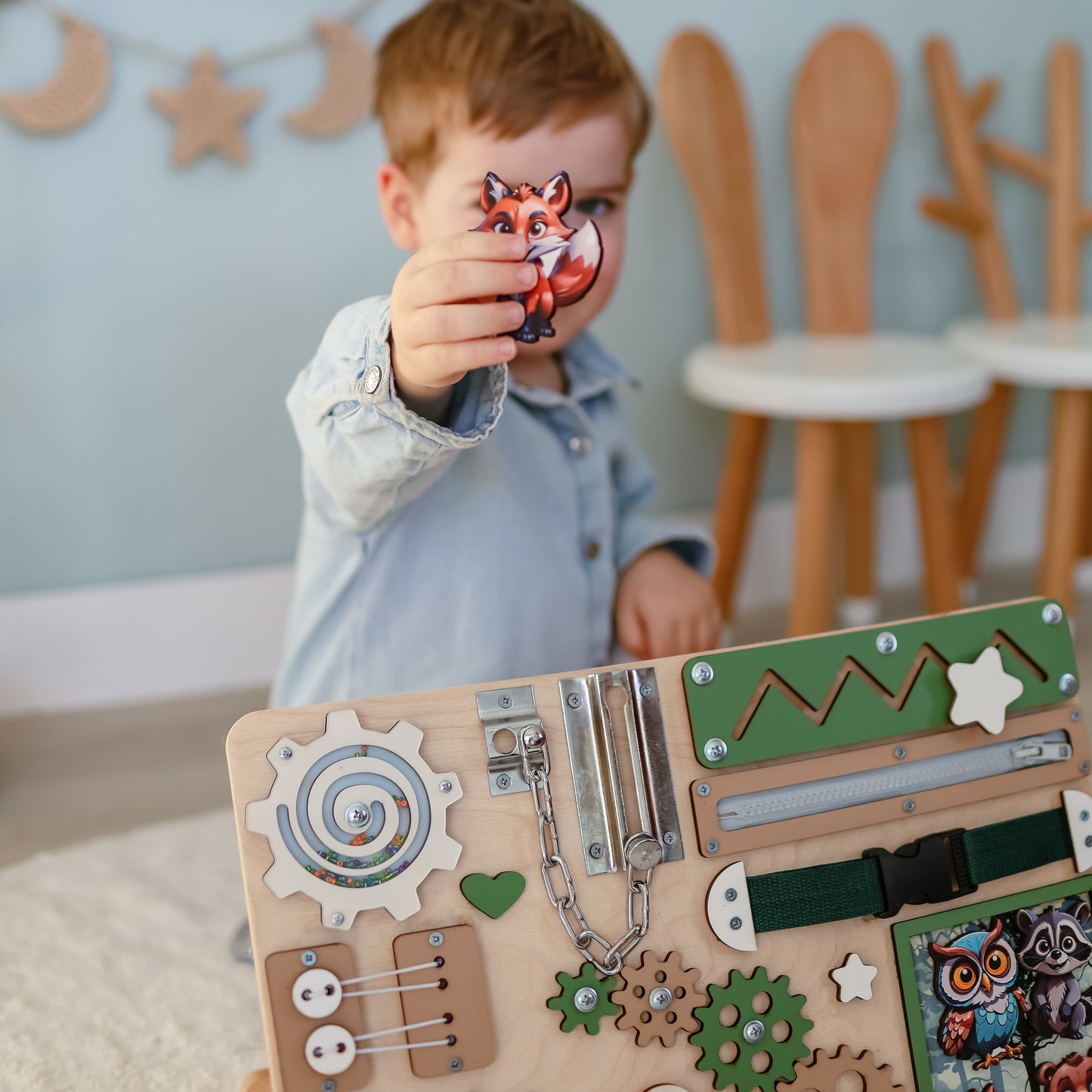 Close-up of removable magnetic animals on a wooden busy board