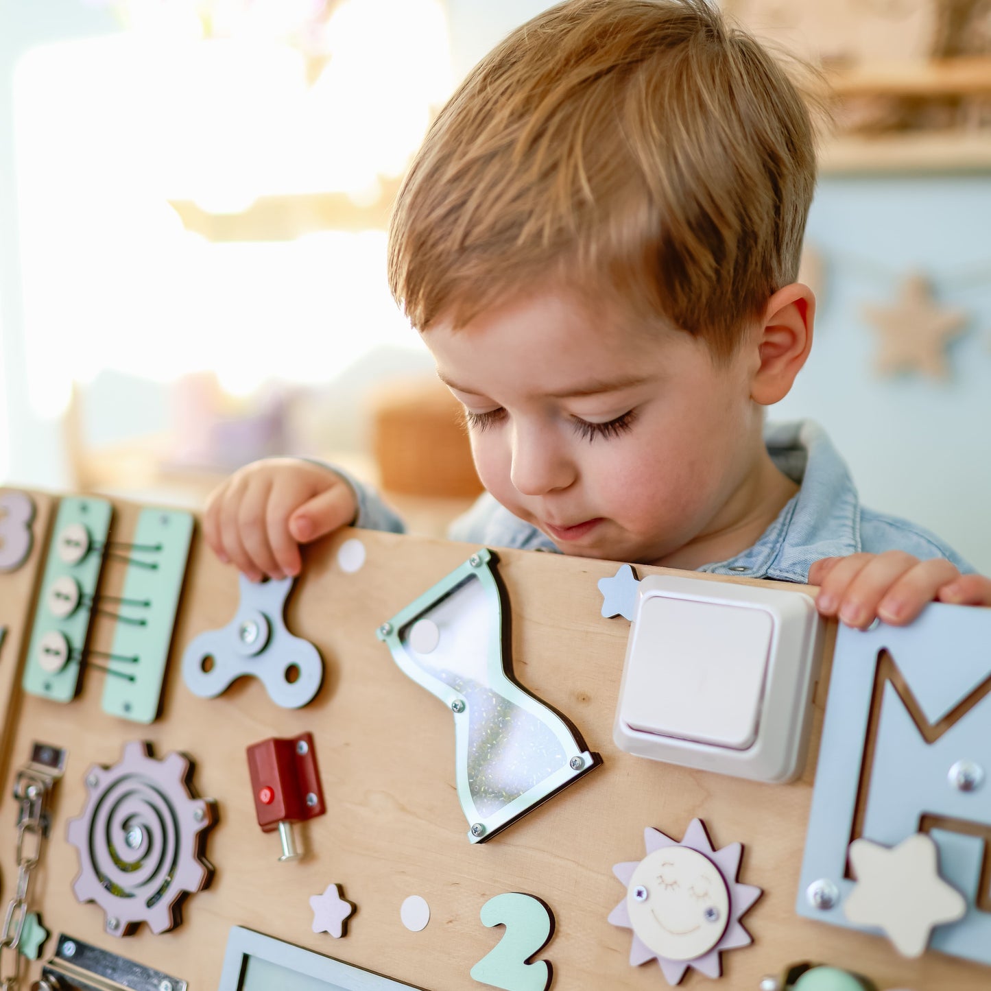 Montessori sensory play board featuring dolphins, whales, and seahorses