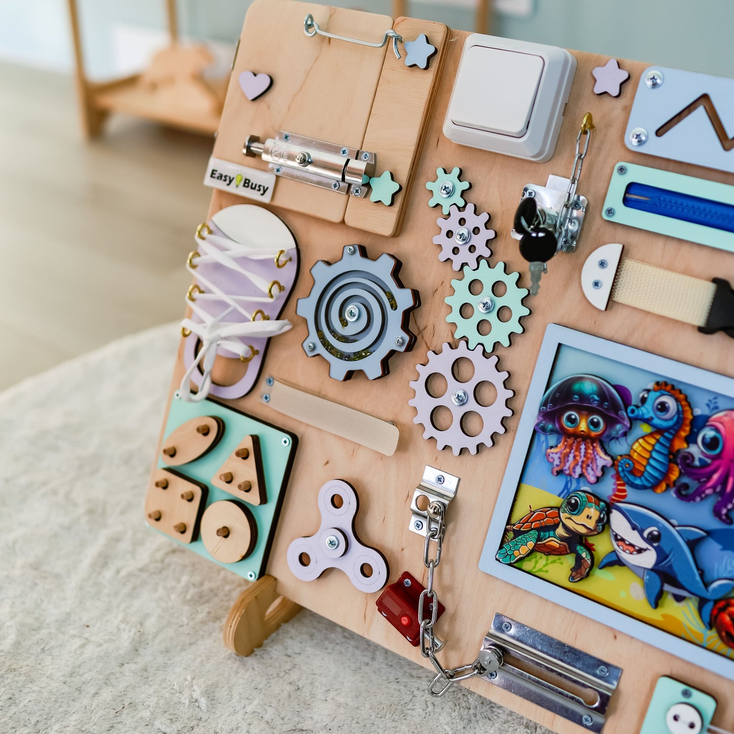 Montessori interactive sensory play board featuring dolphins, turtles, and fish