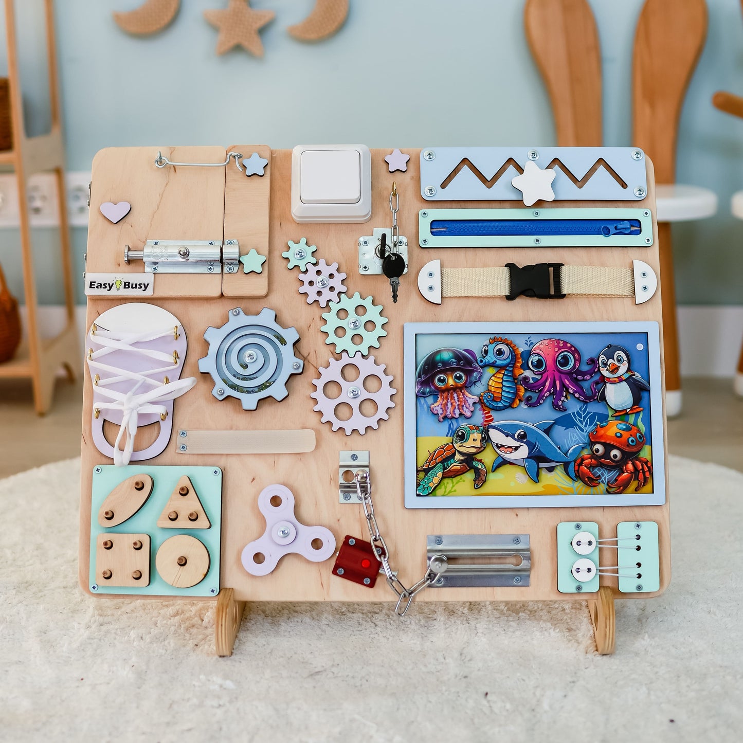 Toddler playing with a beautifully crafted underwater-themed busy board