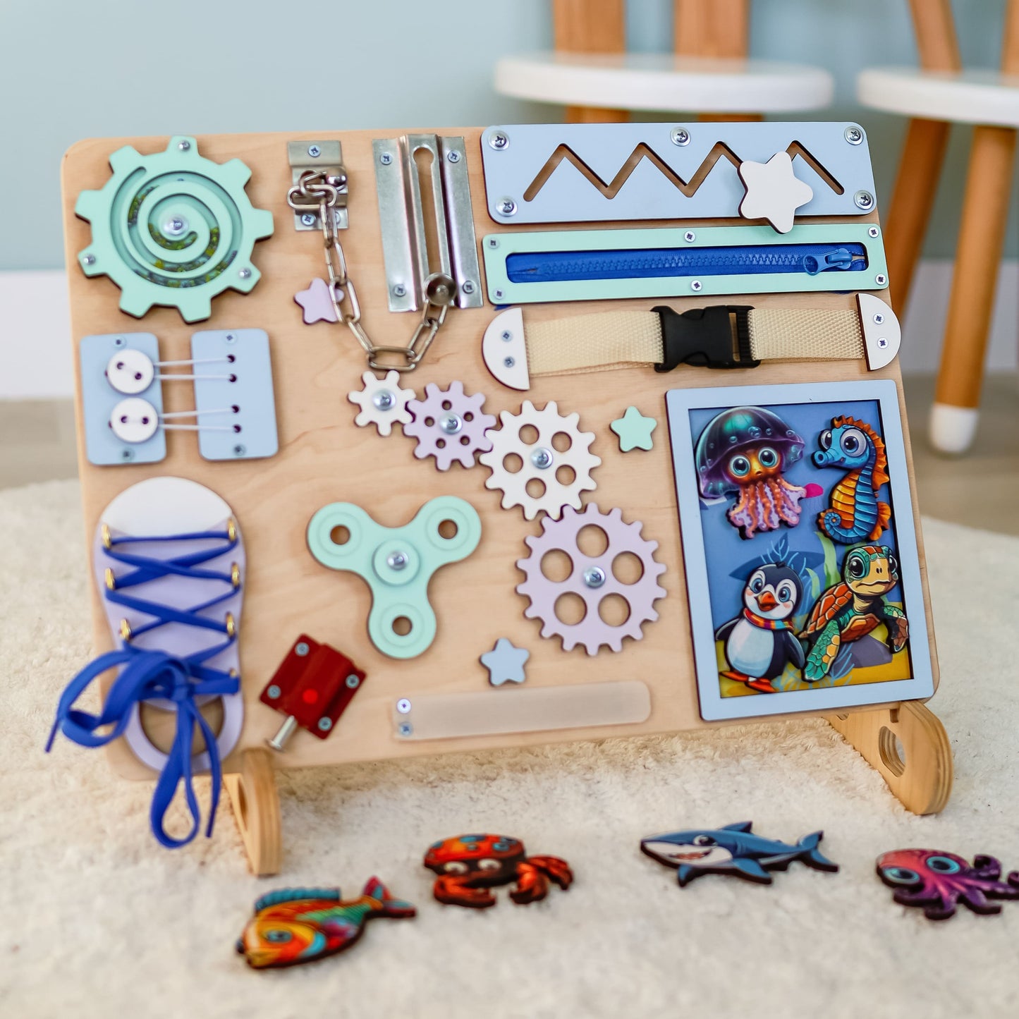 Close-up of removable magnetic fish, dolphins, and crabs on a wooden busy board