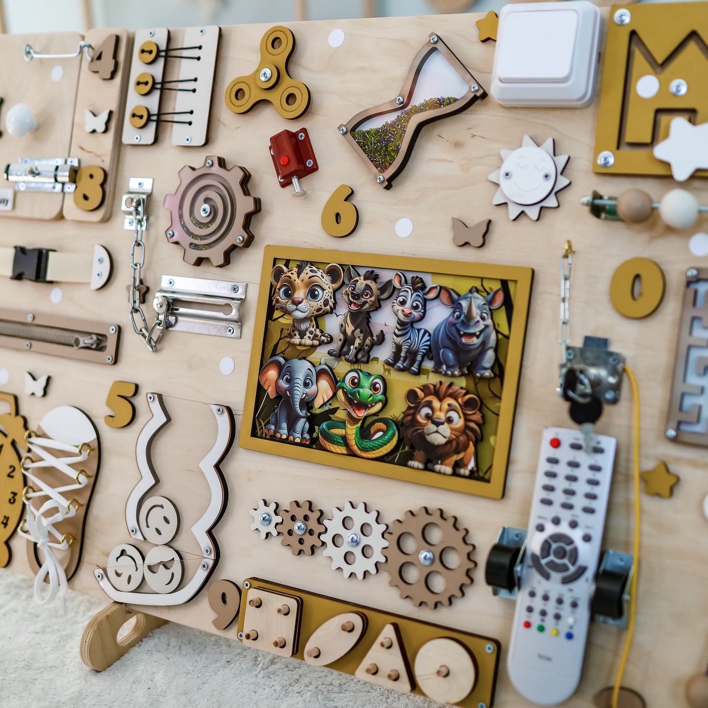 Toddler arranging magnetic safari animals on an interactive activity board
