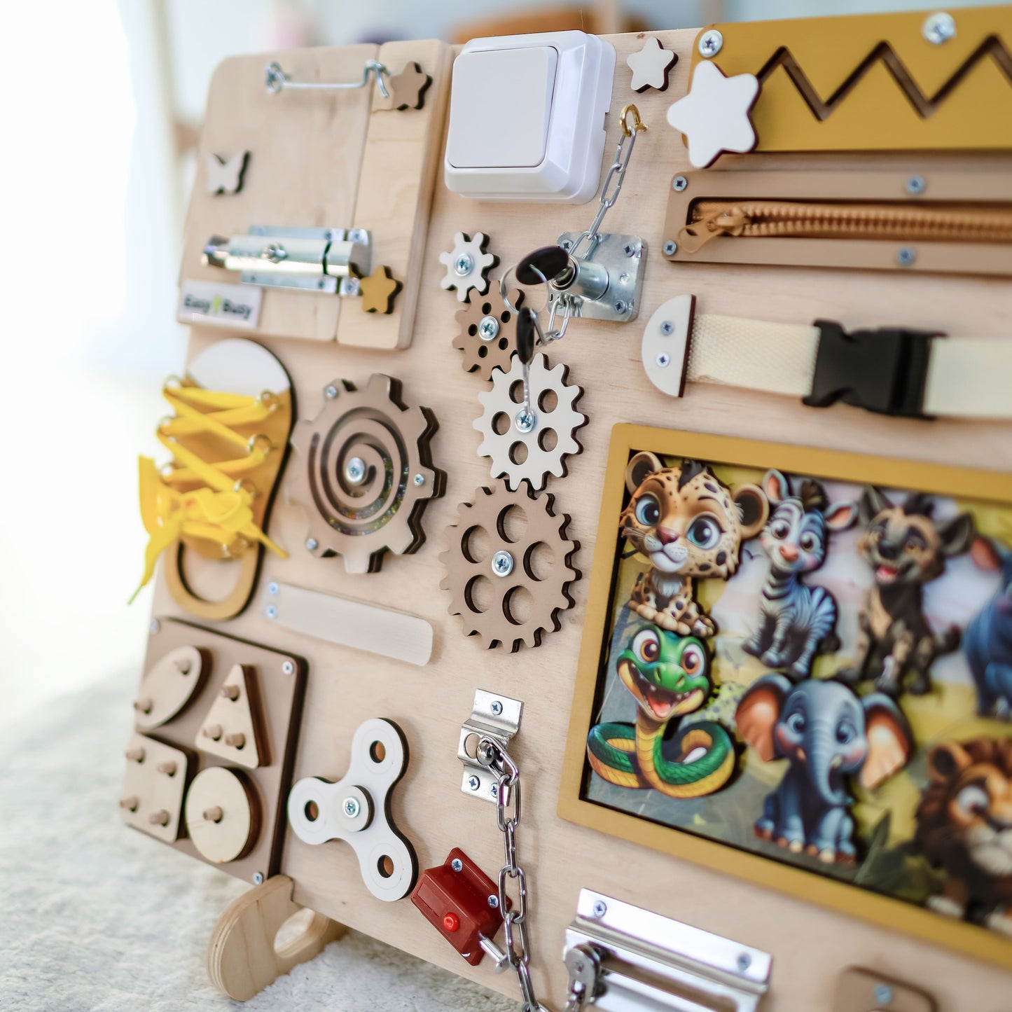 Magnetic lion and giraffe on a wooden busy board for toddlers