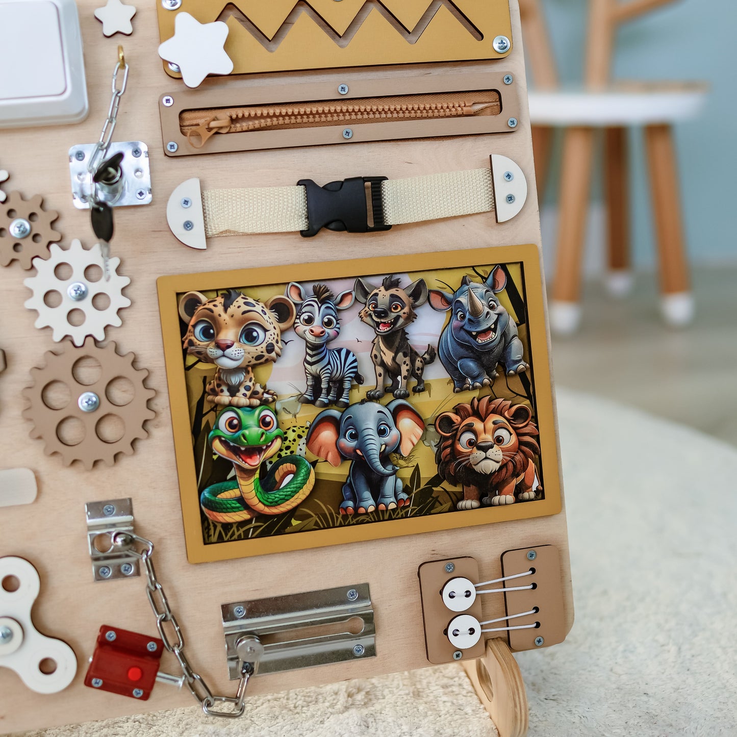 Montessori sensory play board featuring lions, zebras, and elephants