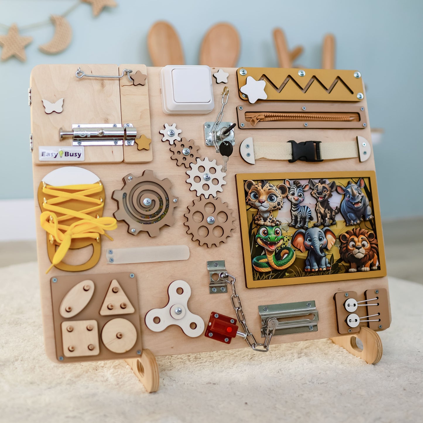Toddler arranging magnetic safari animals on an interactive activity board