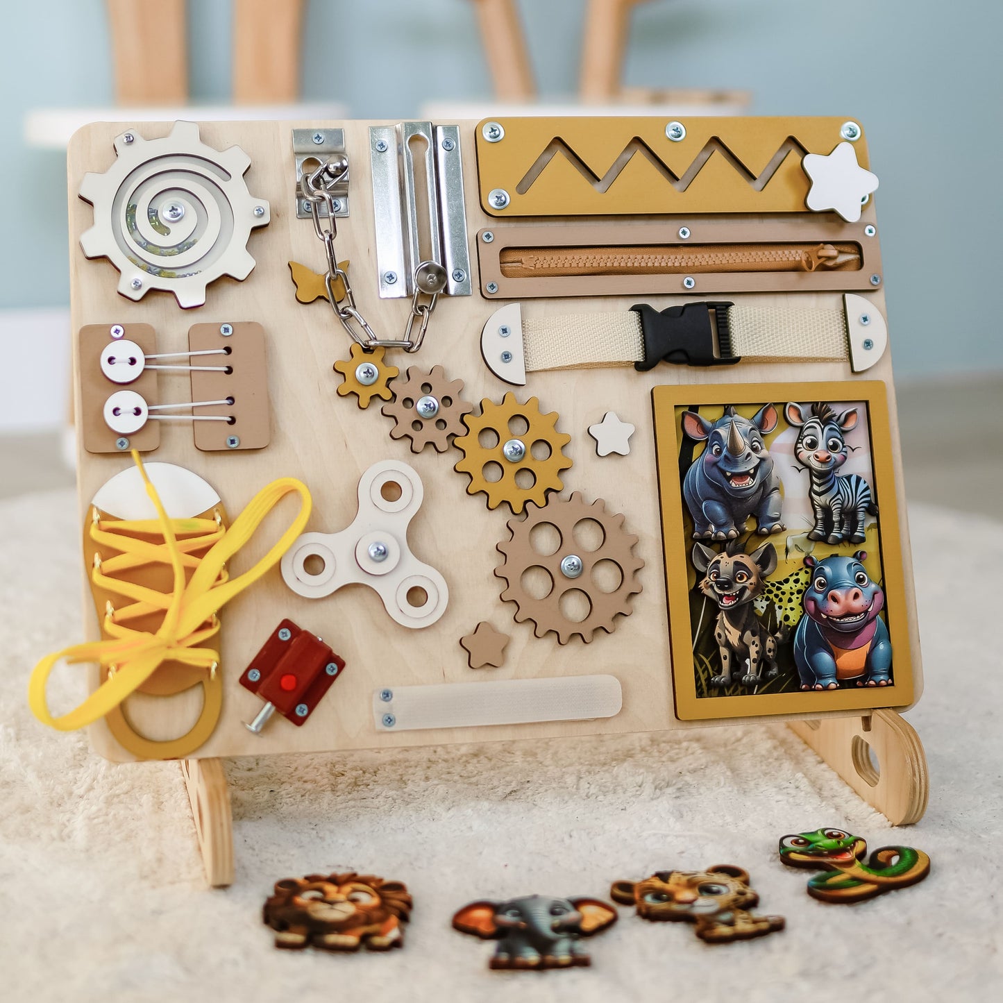 Close-up of removable magnetic animals on a safari sensory board