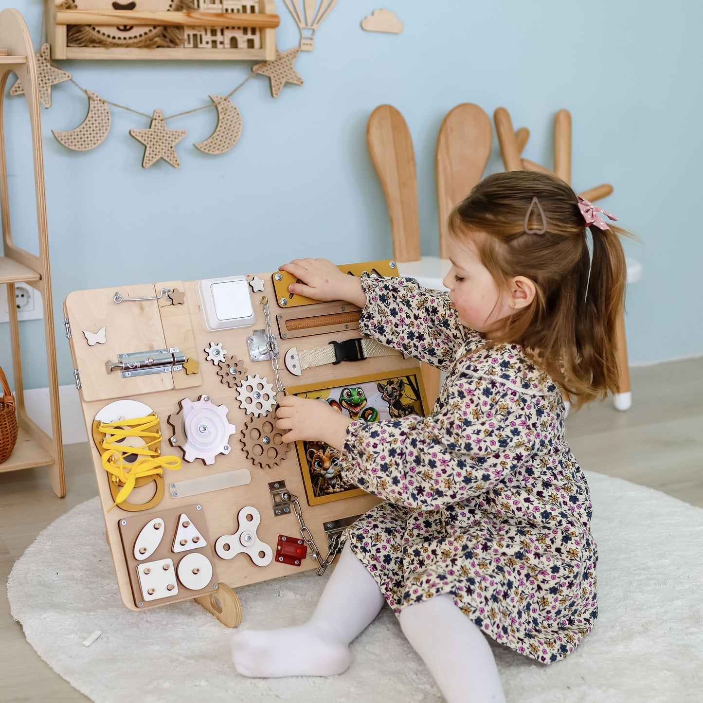 Close-up of removable magnetic animals on a safari sensory board