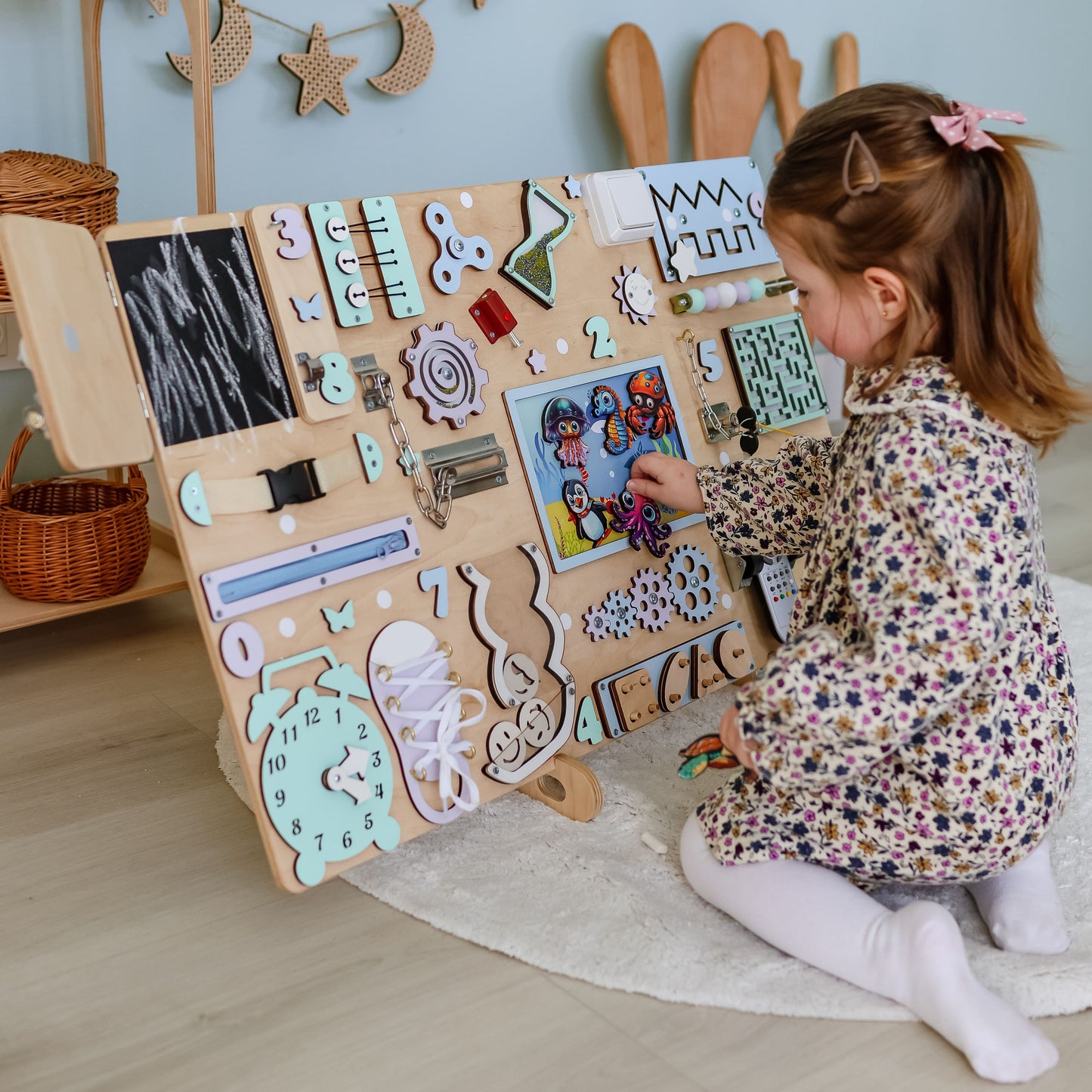 Montessori-inspired sensory board featuring jellyfish, stingrays, and starfish