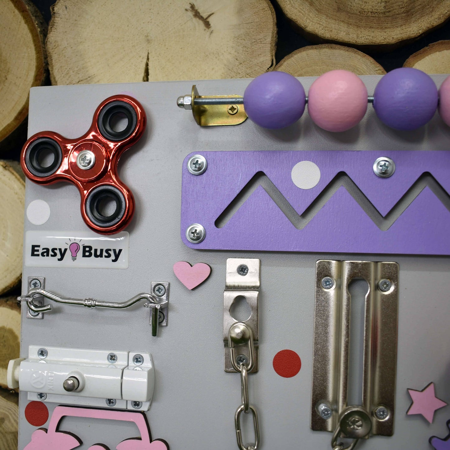 Bright blue busy board with yellow clock and sensory toys