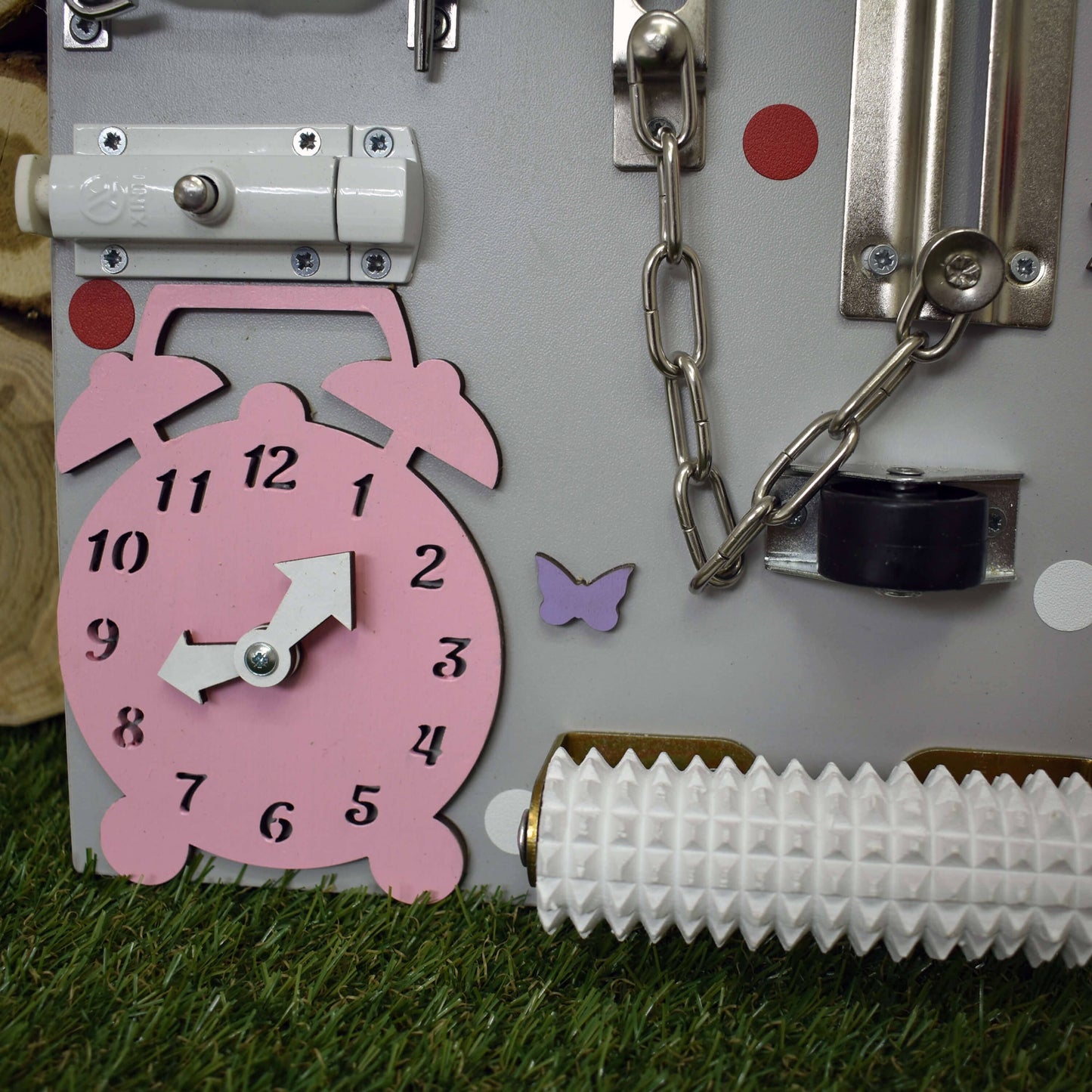 Pink busy board with clock and gears for toddler fine motor development