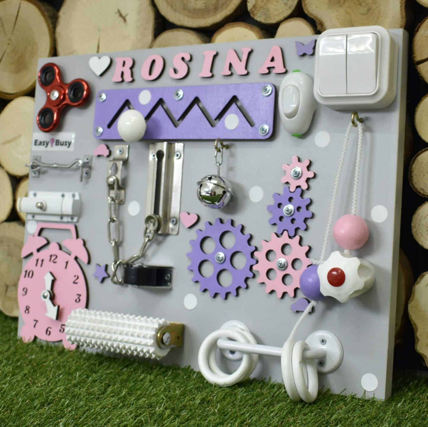 S-size toddler busy board on grass background with clock