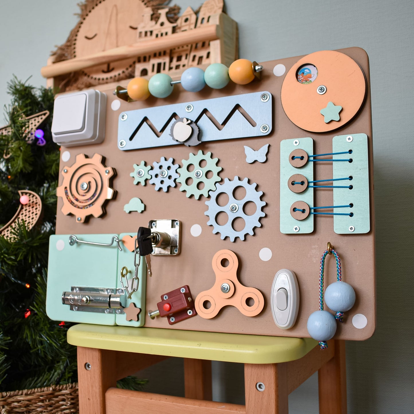 Busy board placed on toddler-size wooden chair