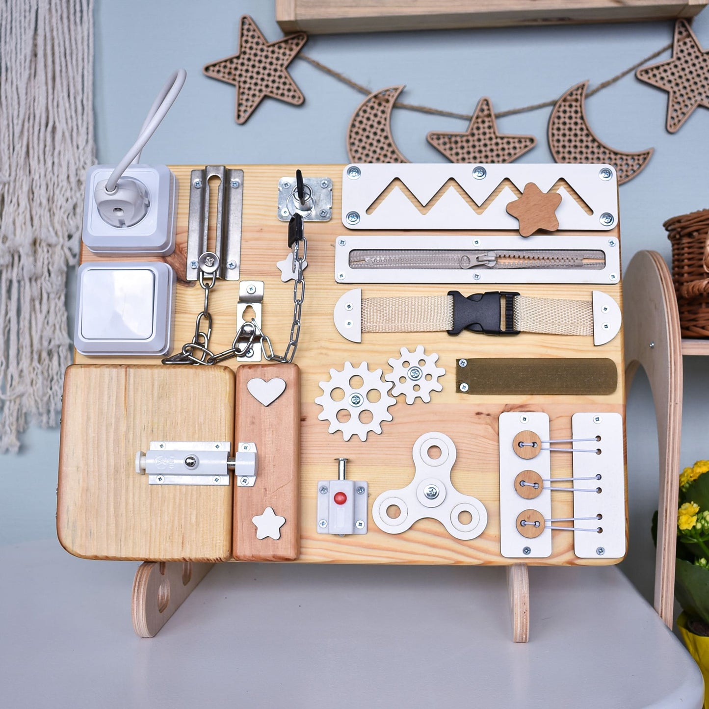 Toddler activity board with spinning gears and locks