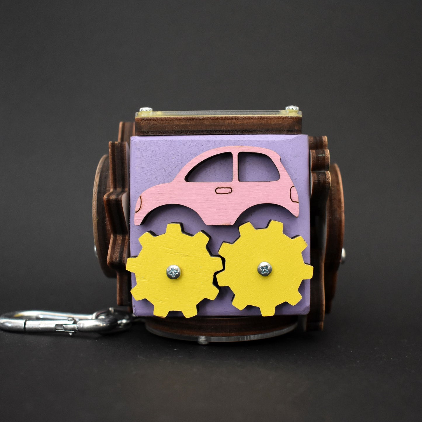 Montessori busy cube in purple and yellow with smiling sun
