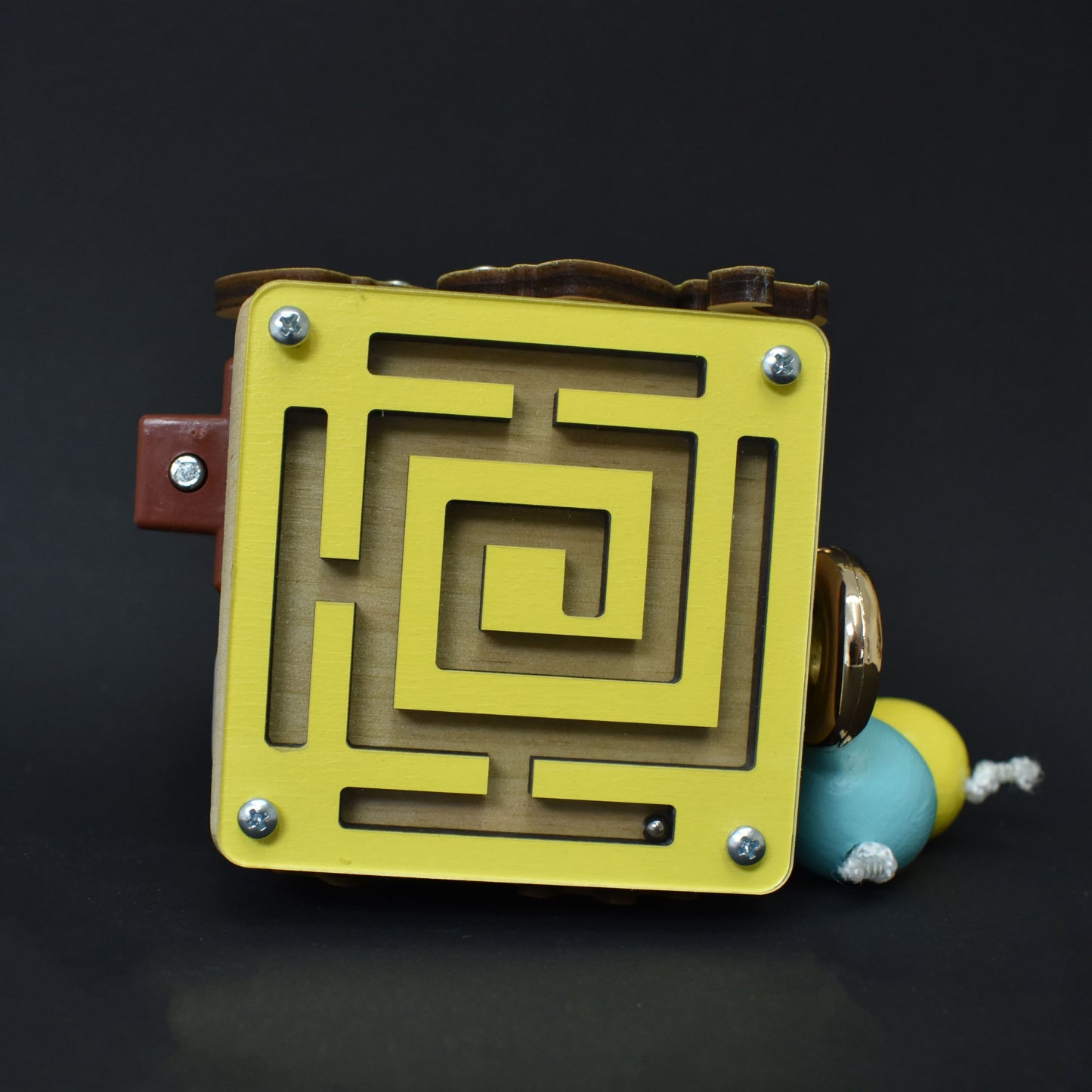 Small wooden activity cube for toddlers
