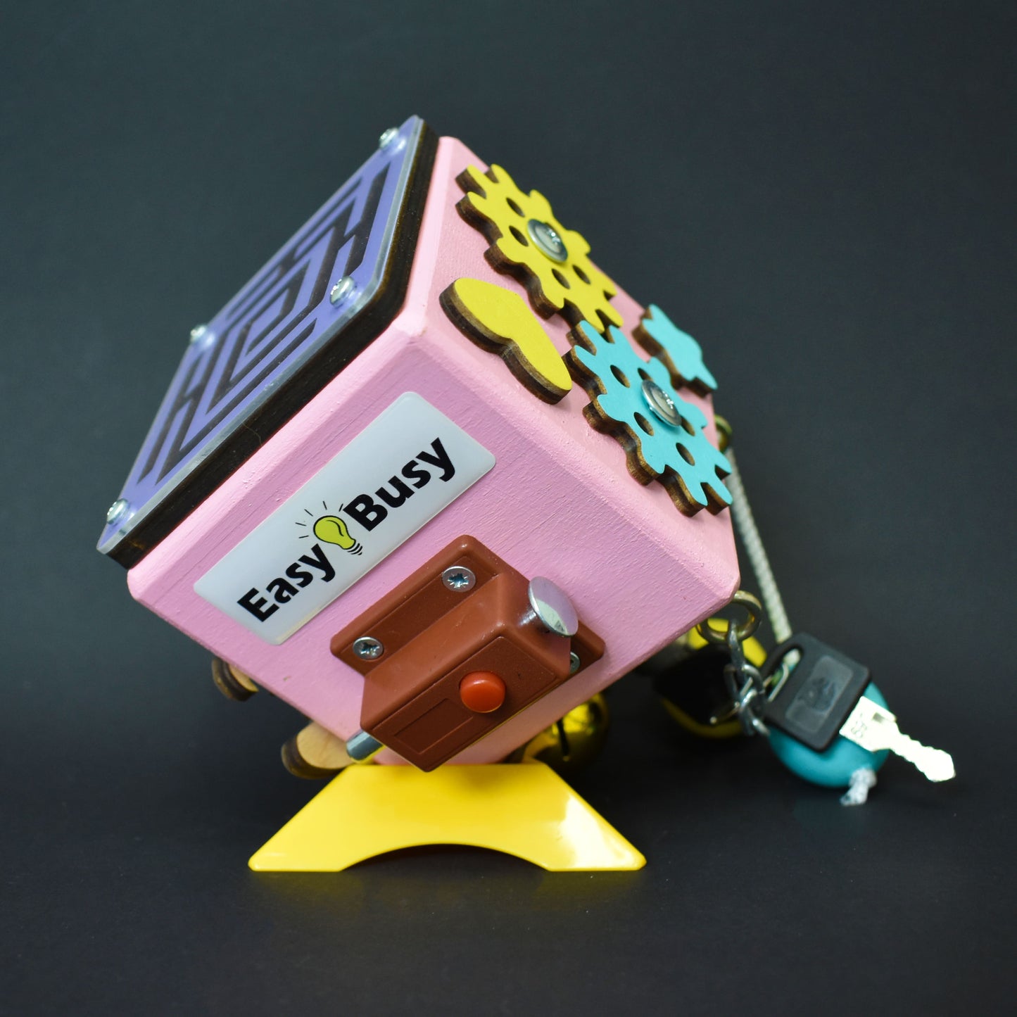 Red and yellow busy cube for motor skill development