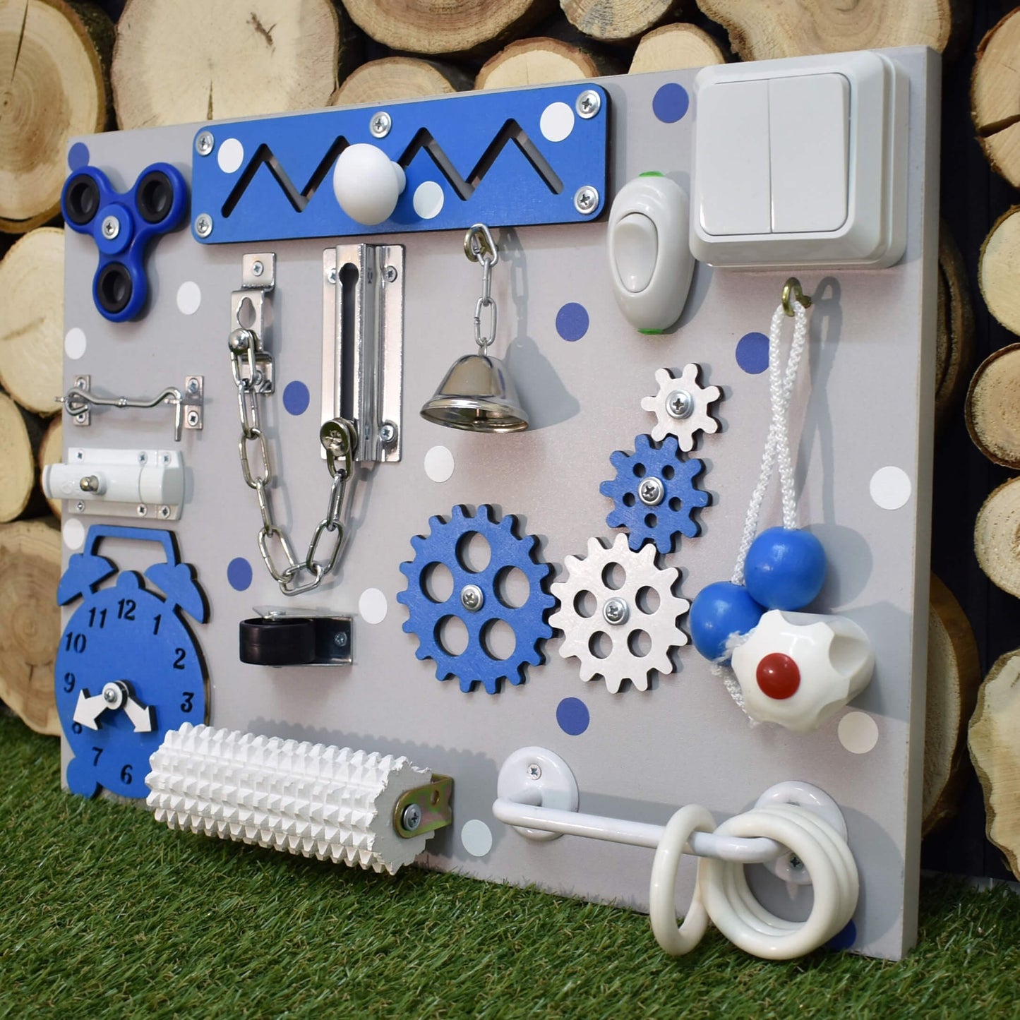 Yellow activity board with bell, clock, and spinner