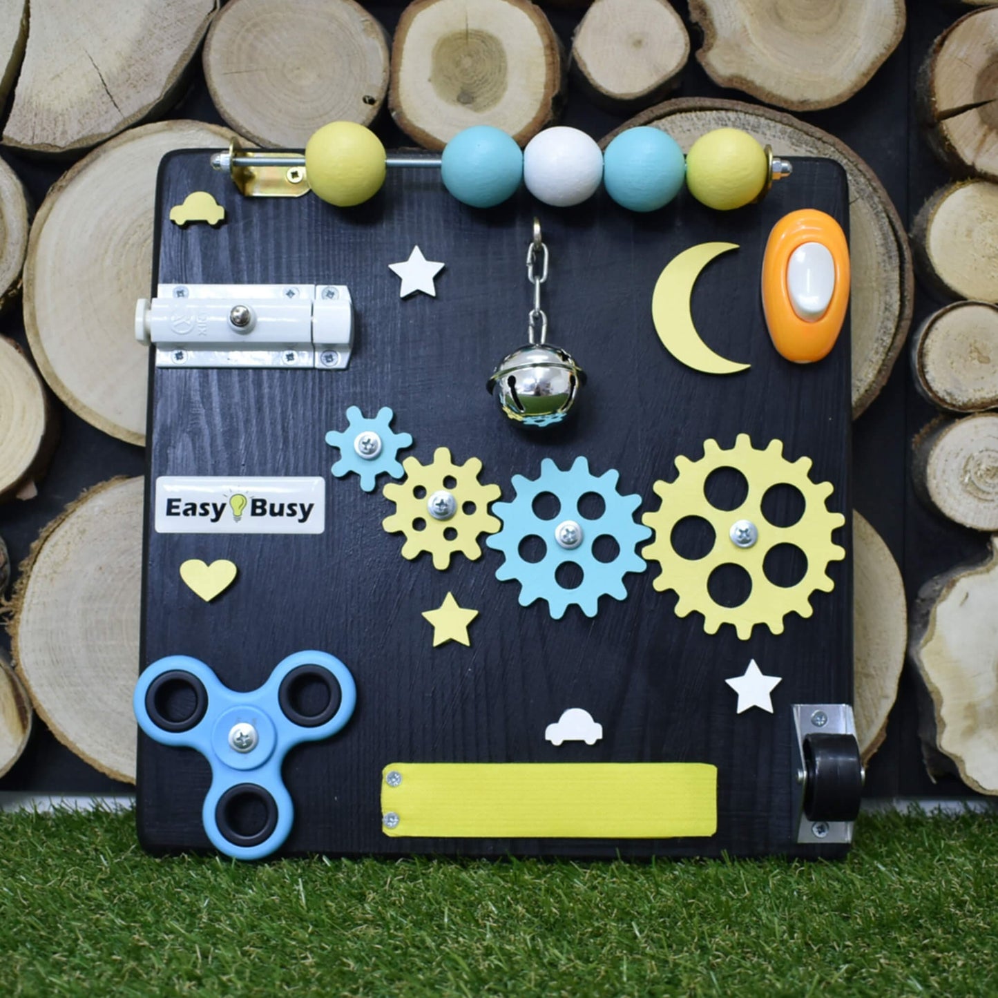 Black Montessori sensory board with pastel gears and switch