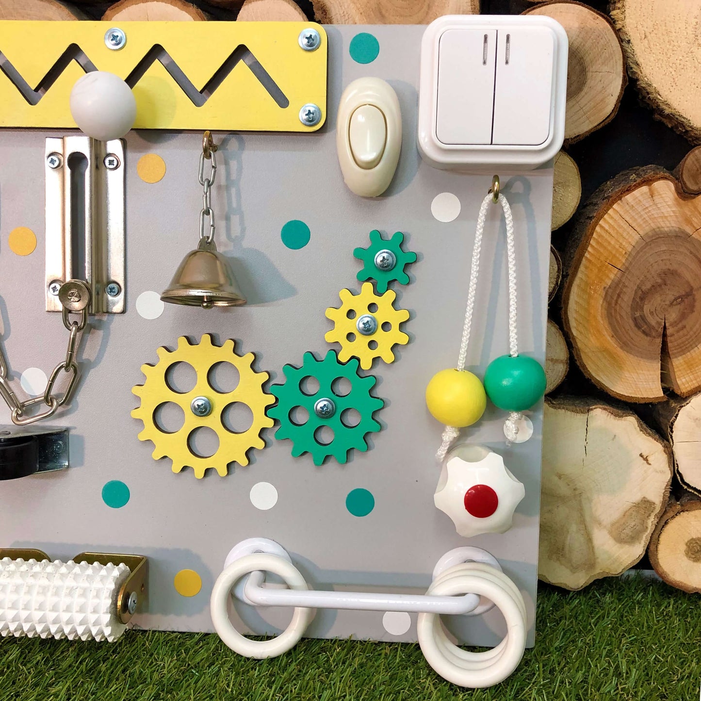 Toddler playing with colorful busy board filled with textures