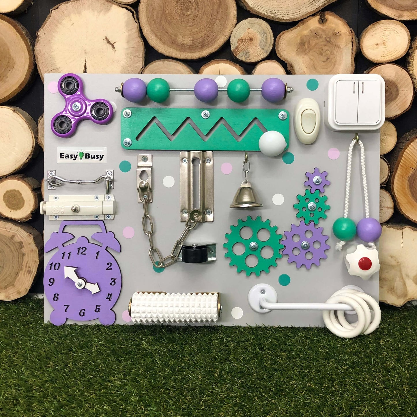 Sensory play board with toggle switch, bell, and spinners