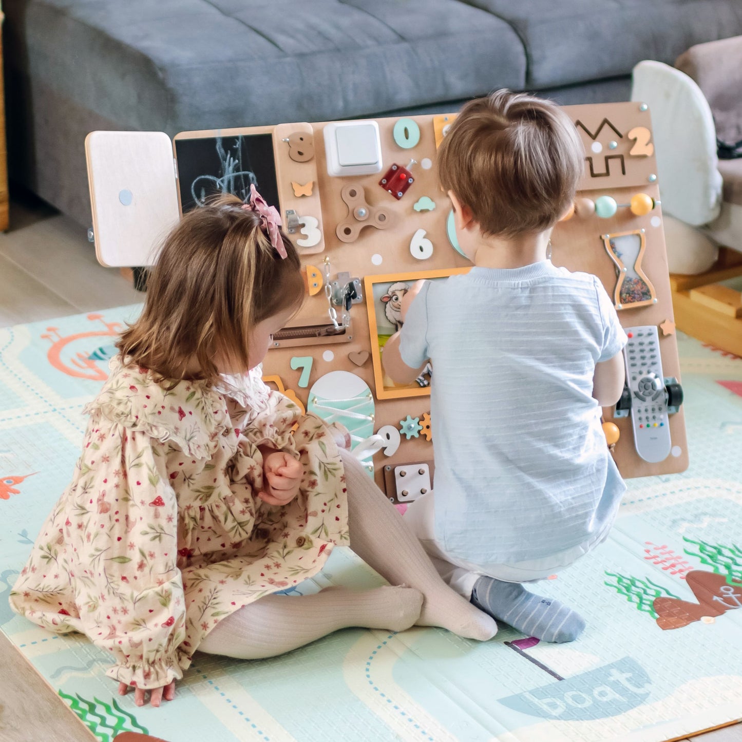 Toddler arranging magnetic farm animals on an oversized activity board