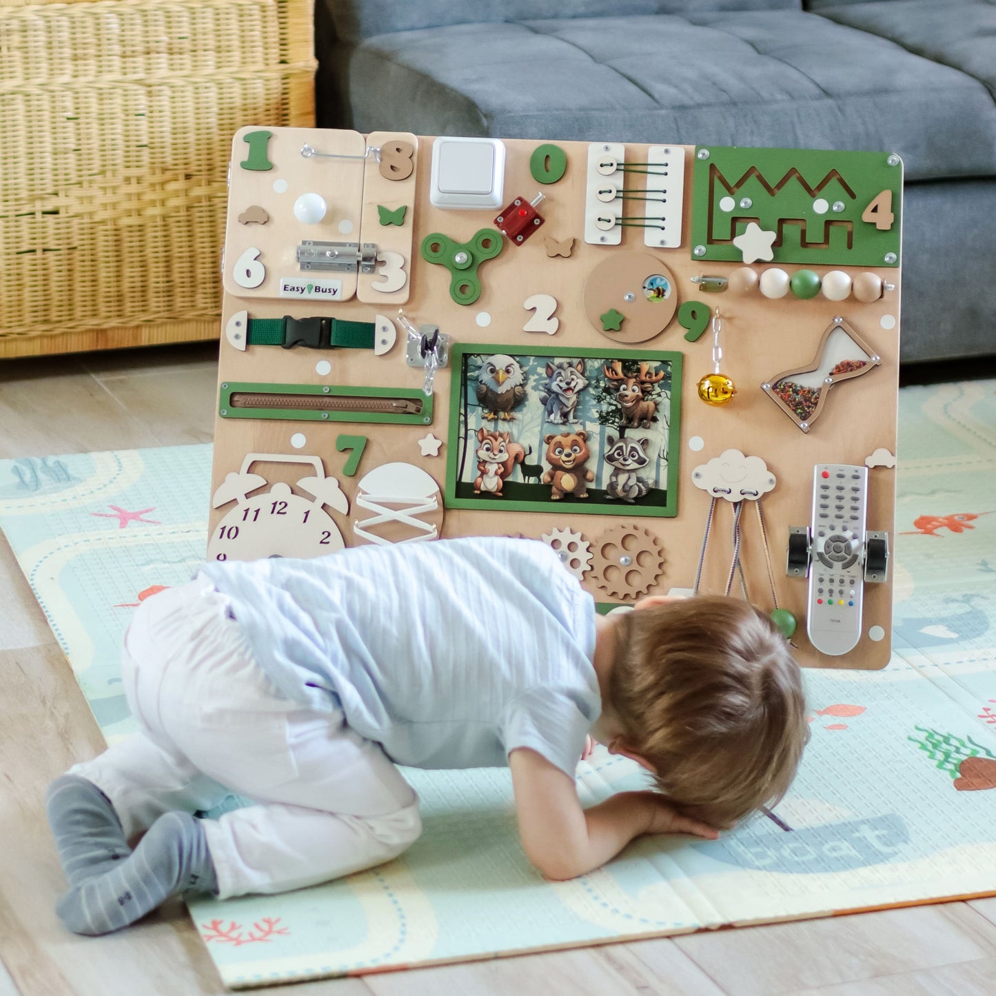 Wall-Mounted Animated Busy Board in a Playroom. The animated busy board securely mounted on a wall, making it a space-saving, decorative, and educational addition to a toddler’s playroom or preschool