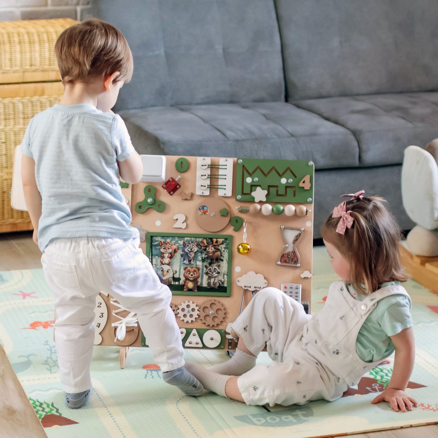 Magnetic Forest Animal Being Moved on the Busy Board. A close-up of a child moving a magnetic forest animal across the busy board, encouraging interactive storytelling and imaginative play
