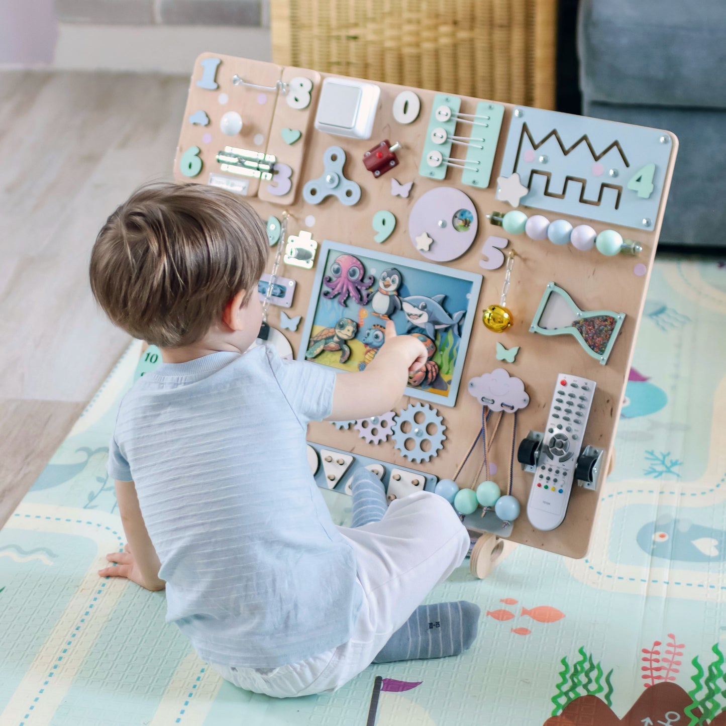 Montessori sensory play board featuring sharks, turtles, and jellyfish