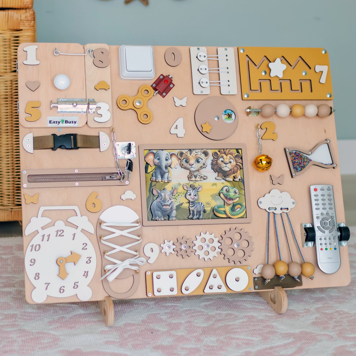 Toddler interacting with a wooden jungle-themed busy board