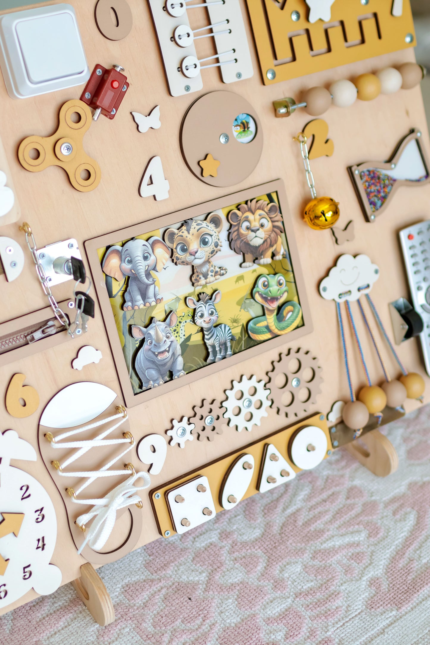 Close-up of magnetic safari animals on a large wooden activity panel