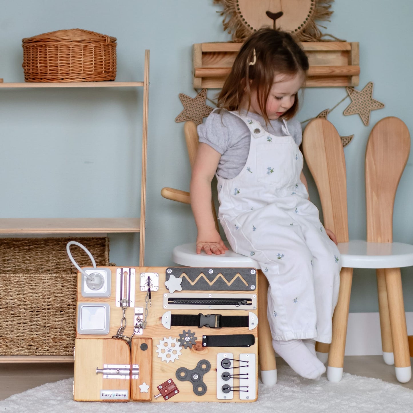 Natural wood toddler busy board with Montessori elements