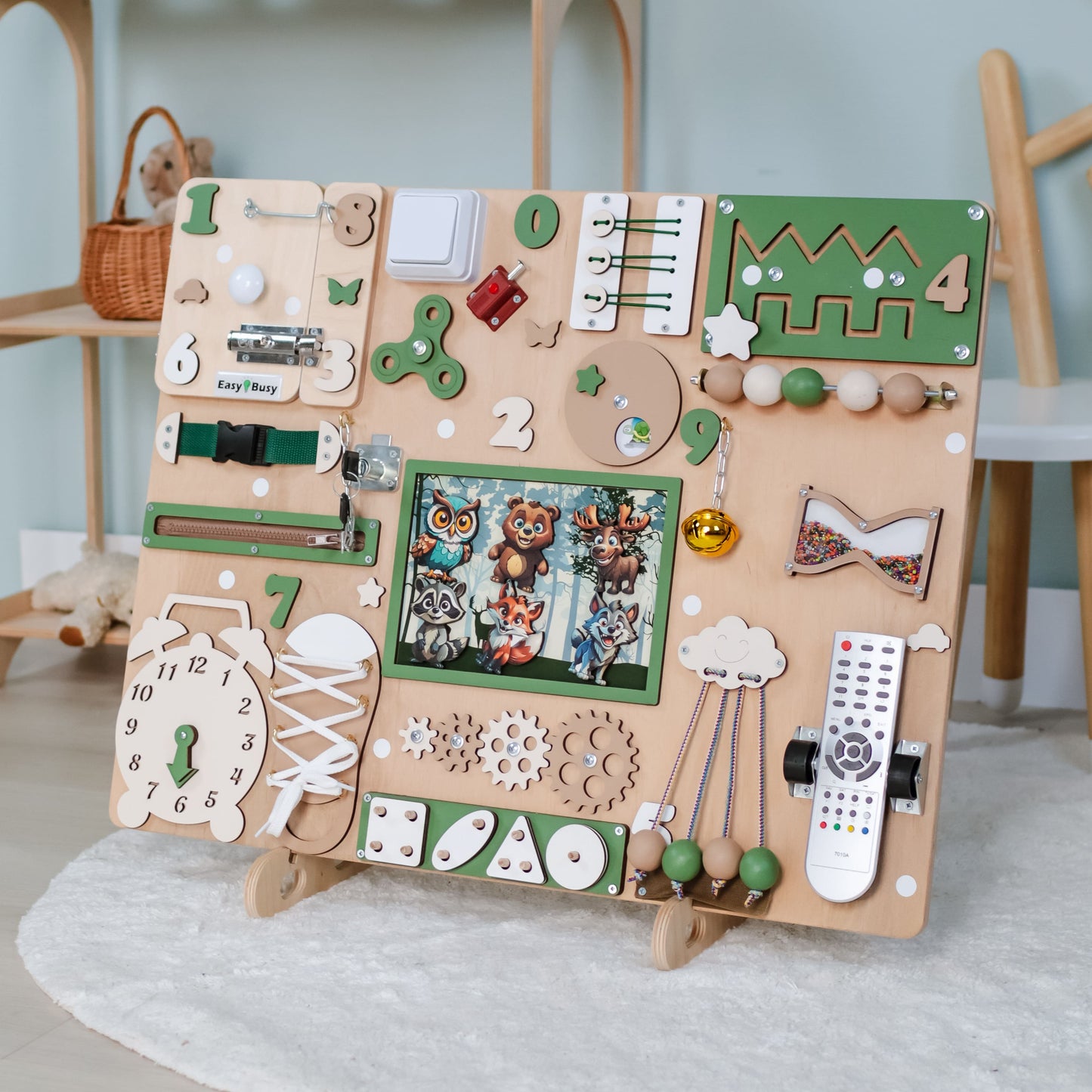 Front View of Animated Busy Board with Forest Animals – A large wooden sensory board featuring realistic magnetic forest animals, buttons, gears, and latches