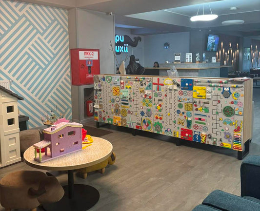 Sensory activity board for commercial use installed in clinic waiting room for kids engagement and sensory play