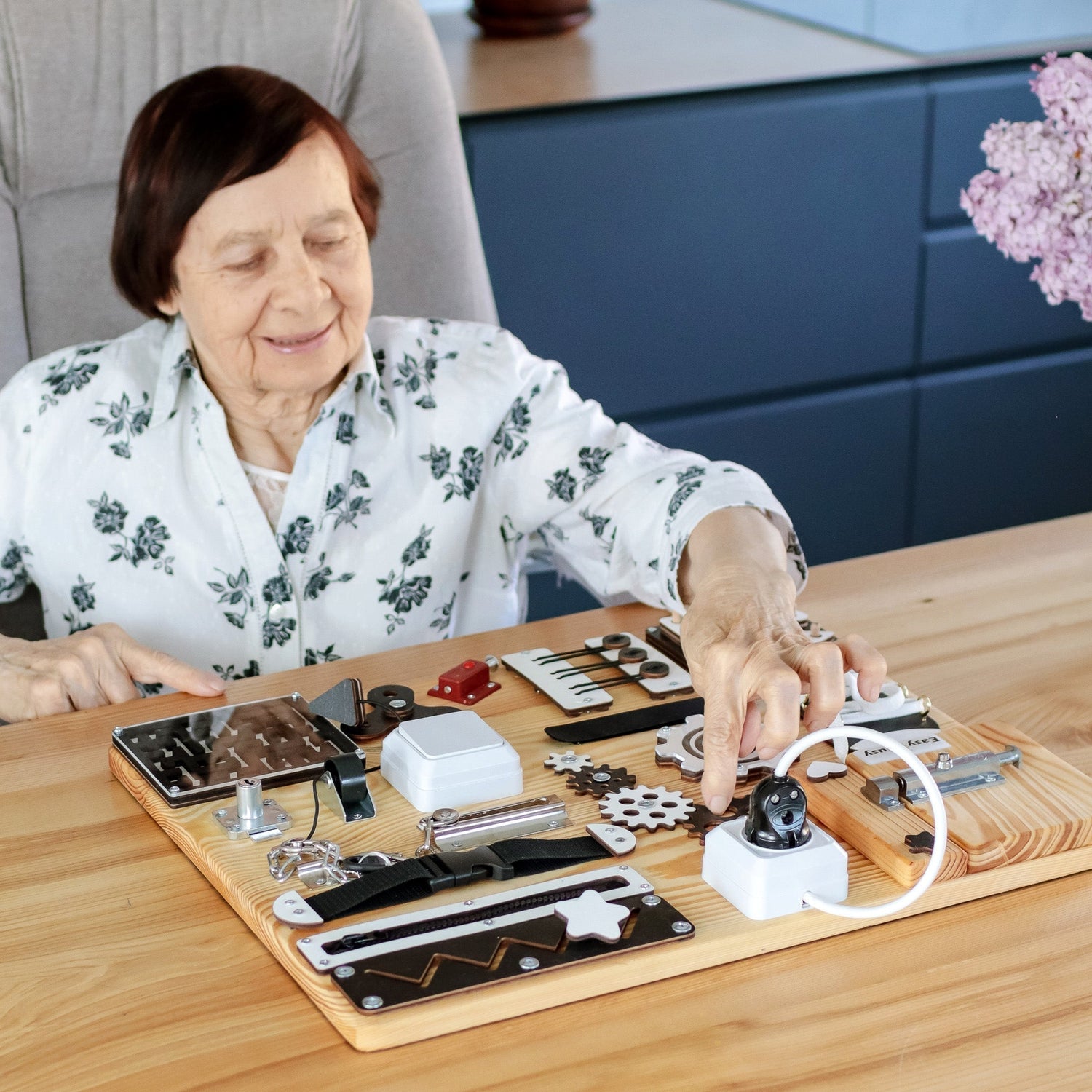 Handmade dementia care product featuring a busyboard designed to improve cognitive skills and provide therapeutic activities for individuals with dementia and Alzheimer’s