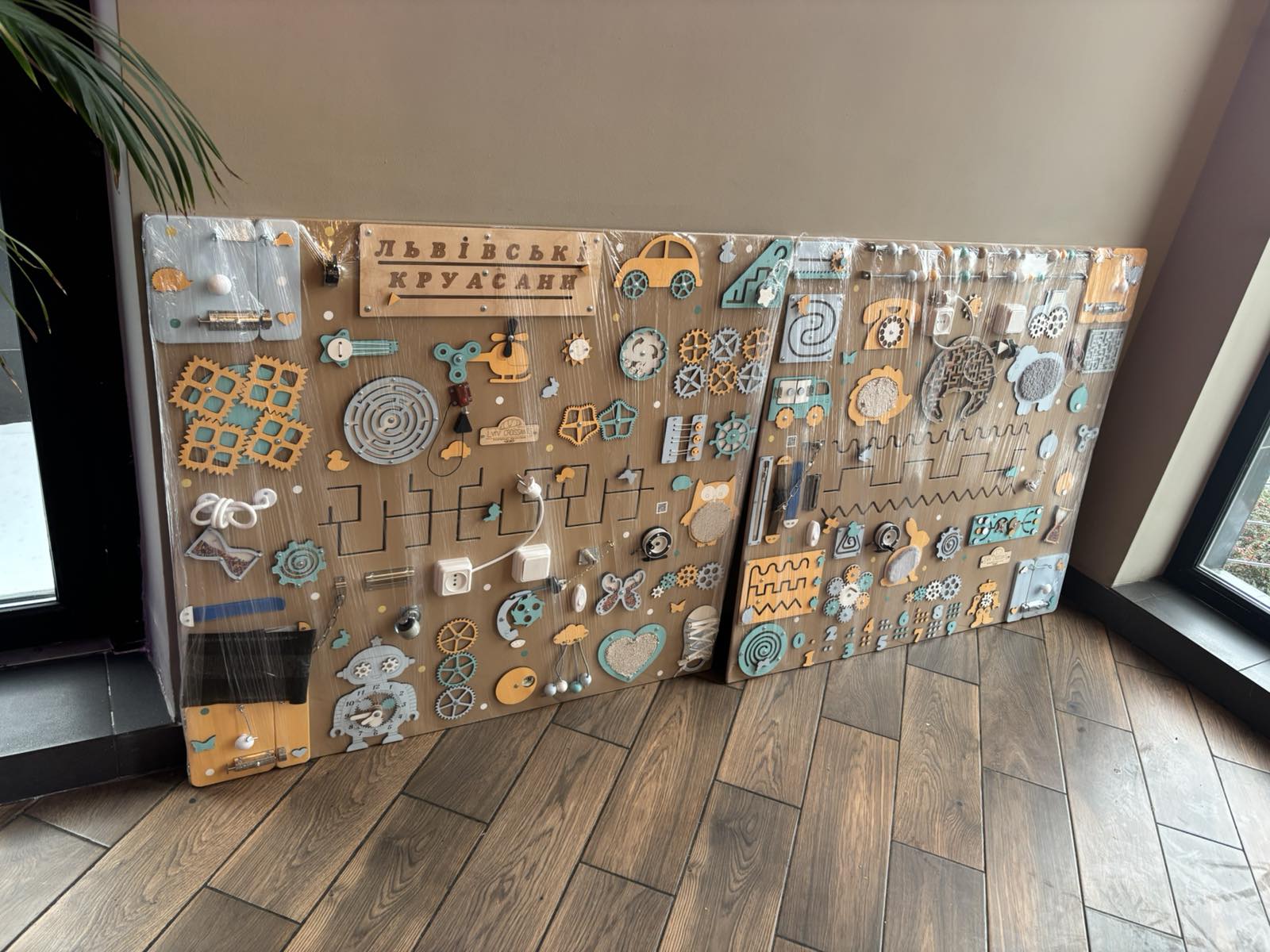 Handmade wooden busy board in workshop production, crafted for durability and long-term use in clinics and therapy centers