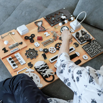 nteractive Dementia Board with Elements – Close-up view of the board's interactive elements, including locks, gears, and switches for fine motor skill improvement