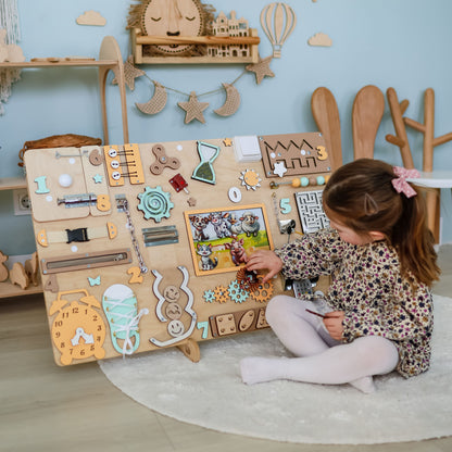 Close-up of magnetic cows, horses, and sheep on a wooden busy board